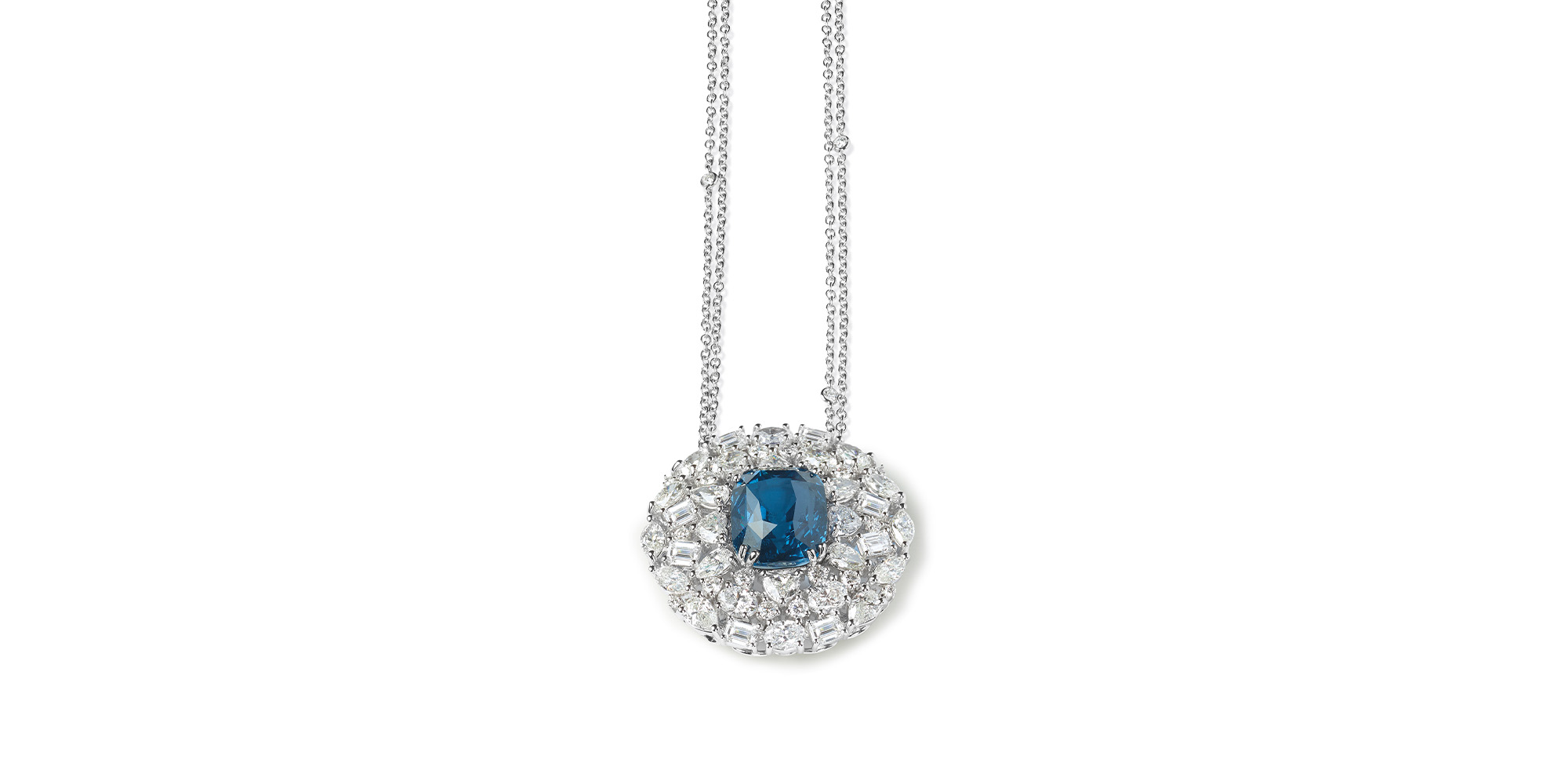 Fantasy Cut Seta The sensation of a luxurious fabric against the skin mirrors the elegance of white gold and the allure of diamonds in various shapes—oval, pear, heart, emerald, navette, and brilliant (10.58 carats). These exquisite gems encircle a remarkable 15.08-carat cushion-cut spinel, radiating an intense cobalt blue, at the center of the pendant.