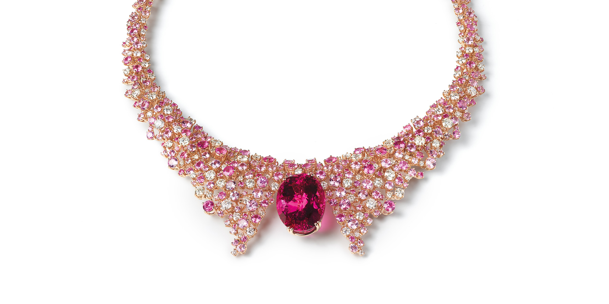 Mimosa Aurora A sumptuous rose gold necklace that enhances the essence of its main showpiece: the vibrant hue of an exceptional oval-cut rubellite (123.84 cts) framed by diamonds, pink sapphires and rubies, whose unique brightness is reminiscent of an early-morning sunrise