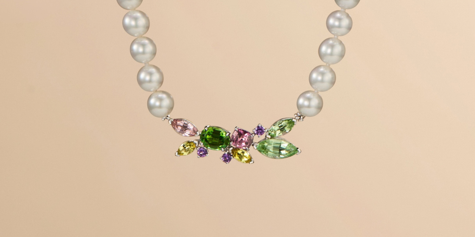 A burst of colour and luminosity.
At the heart of this lustrous South Sea pearl strand sits a vibrant cluster of multicoloured sapphires, layered in shades of pink, green and purple. The unexpected burst of colour brings a contemporary edge to the classic pearl, creating a striking balance of softness, vibrancy and modern sophistication.